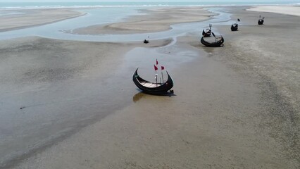 Wooden fishing boat docked on the beach in Cox's Bazar, Bangladesh