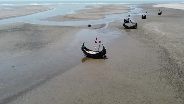 Wooden fishing boat docked on the beach in Cox's Bazar, Bangladesh
