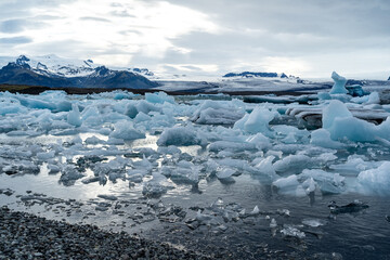 iceberg and floating blocks of ice in glacier lagoon - 514414019