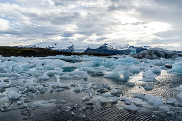 iceberg and floating blocks of ice in glacier lagoon - 514414064