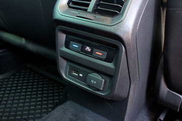Obraz na płótnie Canvas Rear passengers climate control. Modern car USB socket for charging and accessories for passengers, car interior.