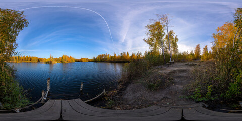 seamless full spherical 360 by 180 degrees panorama of evening autumnal lake with birch forest on...