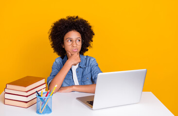 Portrait of beautiful trendy minded teen girl learner preparing project creating solution isolated over bright yellow color background