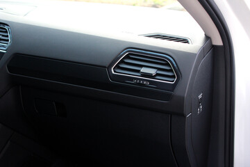 Car air vents close-up grille. Air ventilation grille with power regulator. Modern Car air conditioner, interior of a new modern car.