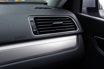 Modern car passenger airbag. Glove compartment in auto interior. Detail of new modern car interior. Black leather interior.