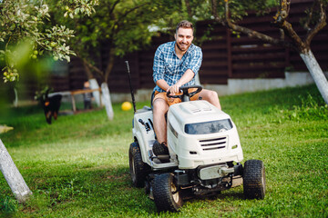 Professional lawn mower cuts the grass. - obrazy, fototapety, plakaty