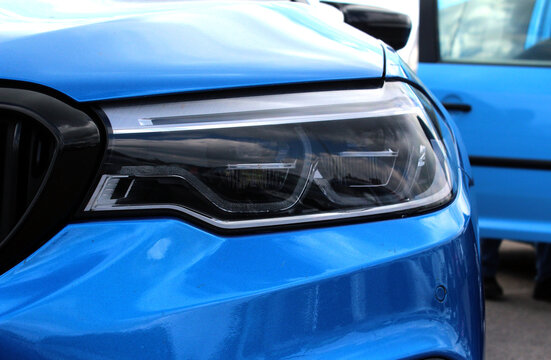 Modern sedan front headlight with headlight washer. Blue car headlight © Best Auto Photo