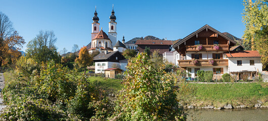 parish church at riverside of Prien river, Aschau im Chiemgau village, autumn landscape