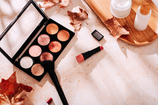 Autumn skincare and autumn makeup concept with beauty products on table