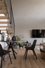 Dining table with decorations in room with tv