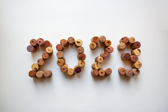 Wine corks 2023 composition isolated on white background from a high angle view