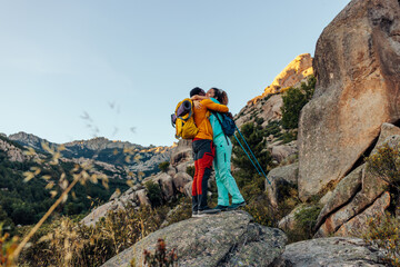 Hiker couple hugging at mountain top