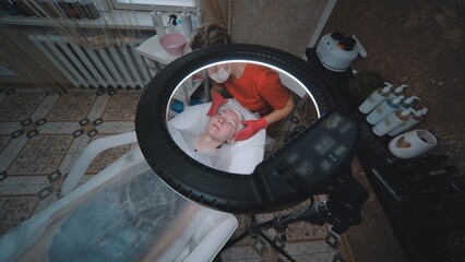 Woman beautician works with a client in a cosmetology office.