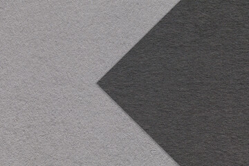 Texture of black and gray paper background, half two colors with arrow, macro. Structure of dense...