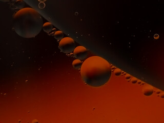 A photo of oil in the backlit water