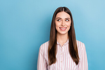 Photo of dreamy shiny lady dressed pink shirt smiling looking empty space isolated blue color background