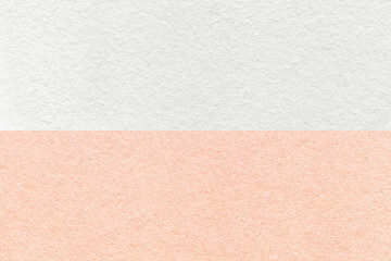 Texture of craft white and pink paper background, half two colors, macro. Structure of vintage dense pearl cardboard.