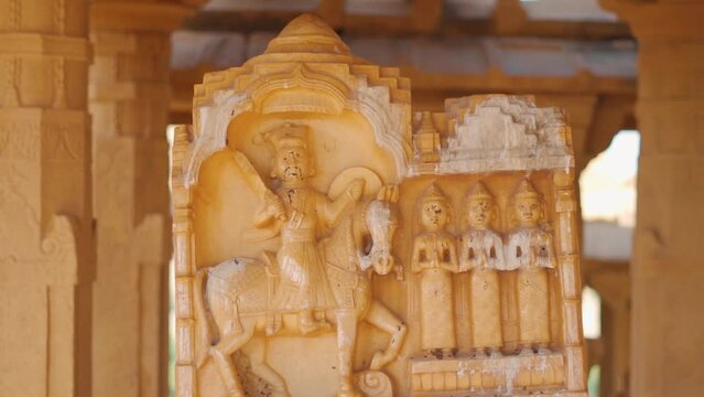 Closeup shot of carved headstone at Bada bagh in Jaisalmer, Rajasthan, India. Ancient head stone carved and made out of sand stone at Jaisalmer. Carved statues of old king on headstones at bada bagh.	
