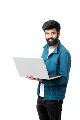 Young indian man using laptop on white background.