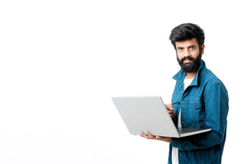 Young indian man using laptop on white background.