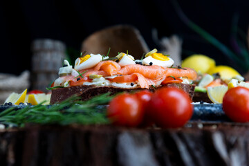 Salted salmon open sandwich with eggs, tomatoes, olives, cream cheese, cucumber and garlick. Healthy seafood