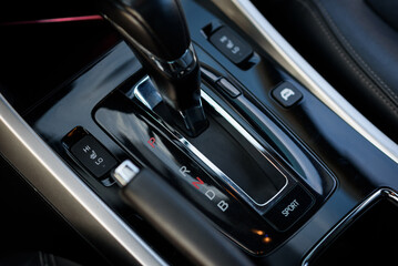 Fototapeta na wymiar Gear shift stick into P position, (parking) symbol in automatic transmission car. Modern automatic gearbox hybrid car. Close up of the gear box transmission handle. Car detailing. Interior car inside.