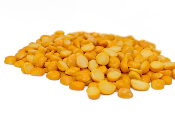 Close-up of Organic Gram (Cicer arietinum) or split yellow chana dal isolated on a white background. Top view