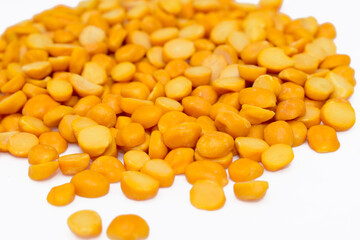Close-up of Organic Gram (Cicer arietinum) or split yellow chana dal isolated on a white background. Top view