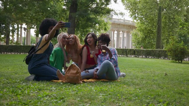 Group of girls taking selfie in park