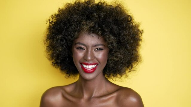 Cheerful black woman with curly hair