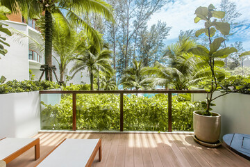 View from resort balcony or terrace on coconut palm trees and turquoise sea. Summer weekend in...