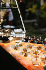 Raw ceviche scallops with kumquat and glasses of champagne. Seafood starters in sea shells are a delicacy.