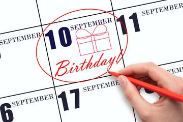 The hand circles the date on the calendar 10 September , draws a gift box and writes the text Birthday. Holiday.