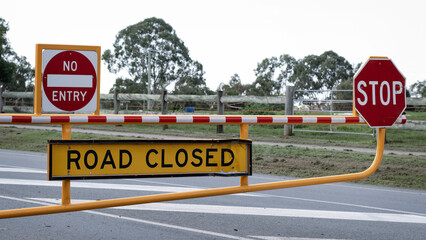 Caution Road Closed No entry Stop signs, warning motorists that the road is closed due to flooding.  