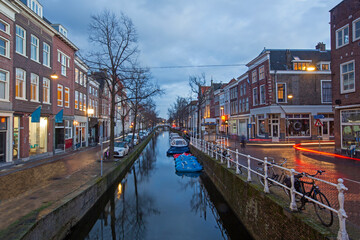 Canals in the old city of Delft, South Holland illuminated at dusk in the Netherlands