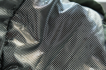 wrinkled fabric of a modern down jacket. © yavdat