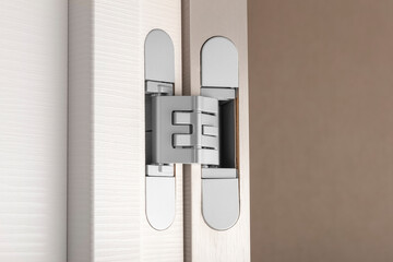 Modern aluminum door hinges on white doors. Copy space, place for text. Close-up
