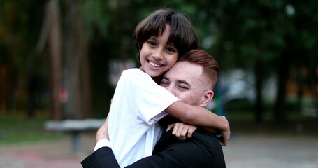 Caring loving moment of son kissing father cheek. Ethnically diverse family parent and child love and care