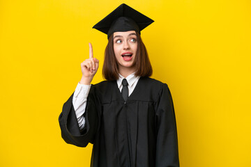 Young university graduate Ukrainian woman isolated on yellow background intending to realizes the solution while lifting a finger up