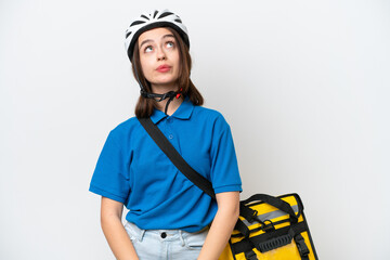 Young Ukrainian woman with thermal backpack isolated on white background and looking up