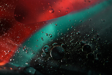 Abstract oil droplets in water reflecting the colors of a background to give a planet effect