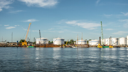 Industrial cranes in port at sunny day