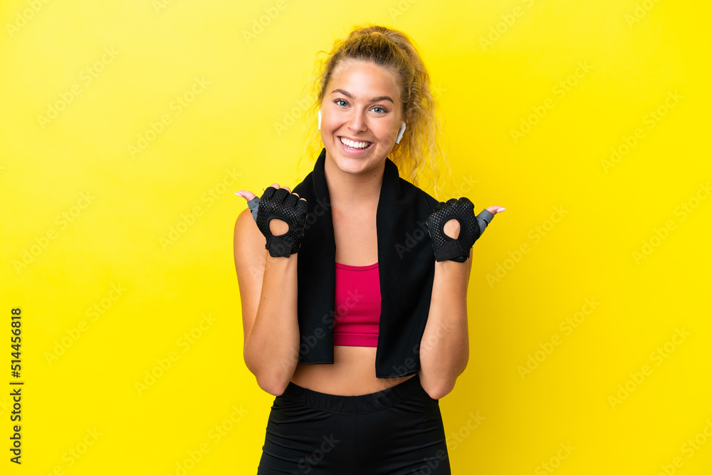 Wall mural Sport woman with towel isolated on yellow background with thumbs up gesture and smiling