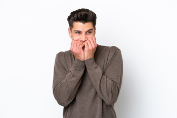Young handsome caucasian man isolated on white bakcground nervous and scared putting hands to mouth