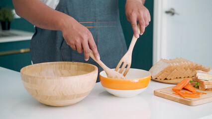 Close-up of the hands of this man who is preparing, preparing food for his partner to eat in the morning, before leaving the house to go to work. The love, and friendship of LGBTQ couples.