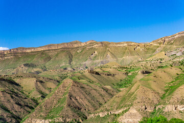 mountain landscape with a huge geological fault, a canyon wall with cliffs, screes and alluvial fans