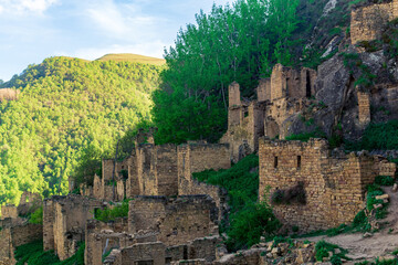 ruins of houses on a mountainside in the empty village of Gamsutl, Dagestan