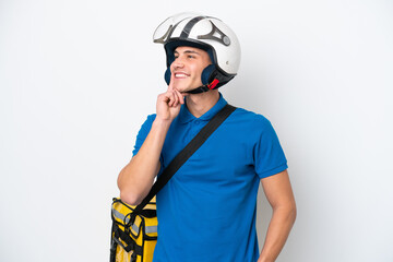 Young caucasian man with thermal backpack isolated on white background thinking an idea while looking up