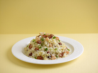 Yang Zhou Fried Rice served in a dish isolated on cutting board side view on dark background
