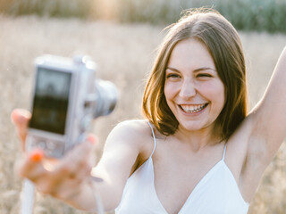 woman taking photo with camera, self portrait